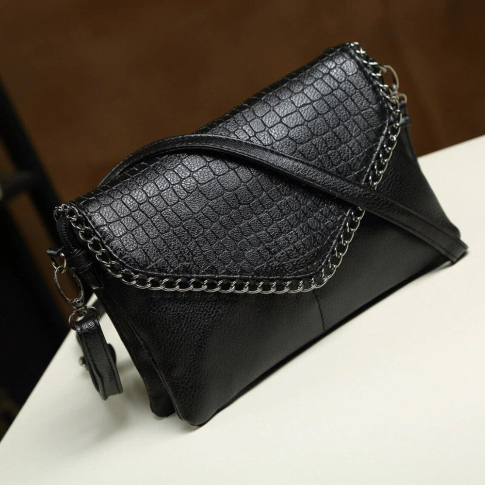 Elegant clutch tas med kædedetalje